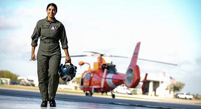 Cristina Silva walking with coast guard helicopter in background.